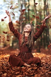 beautiful-young-woman-throwing-leaves-autumn-forest