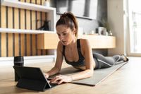 full-shot-woman-mat-with-tablet