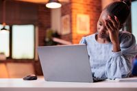 stressed-young-female-freelancer-having-headache-working-laptop-corporate-employee-burnout-concept-tired-busy-african-american-businesswoman-unhappy-employee-workplace