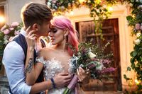 stylish-groom-hugs-from-beautiful-bride-with-pink-hair