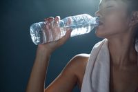 women-after-exercise-drink-water-from-bottles-handkerchiefs-gym